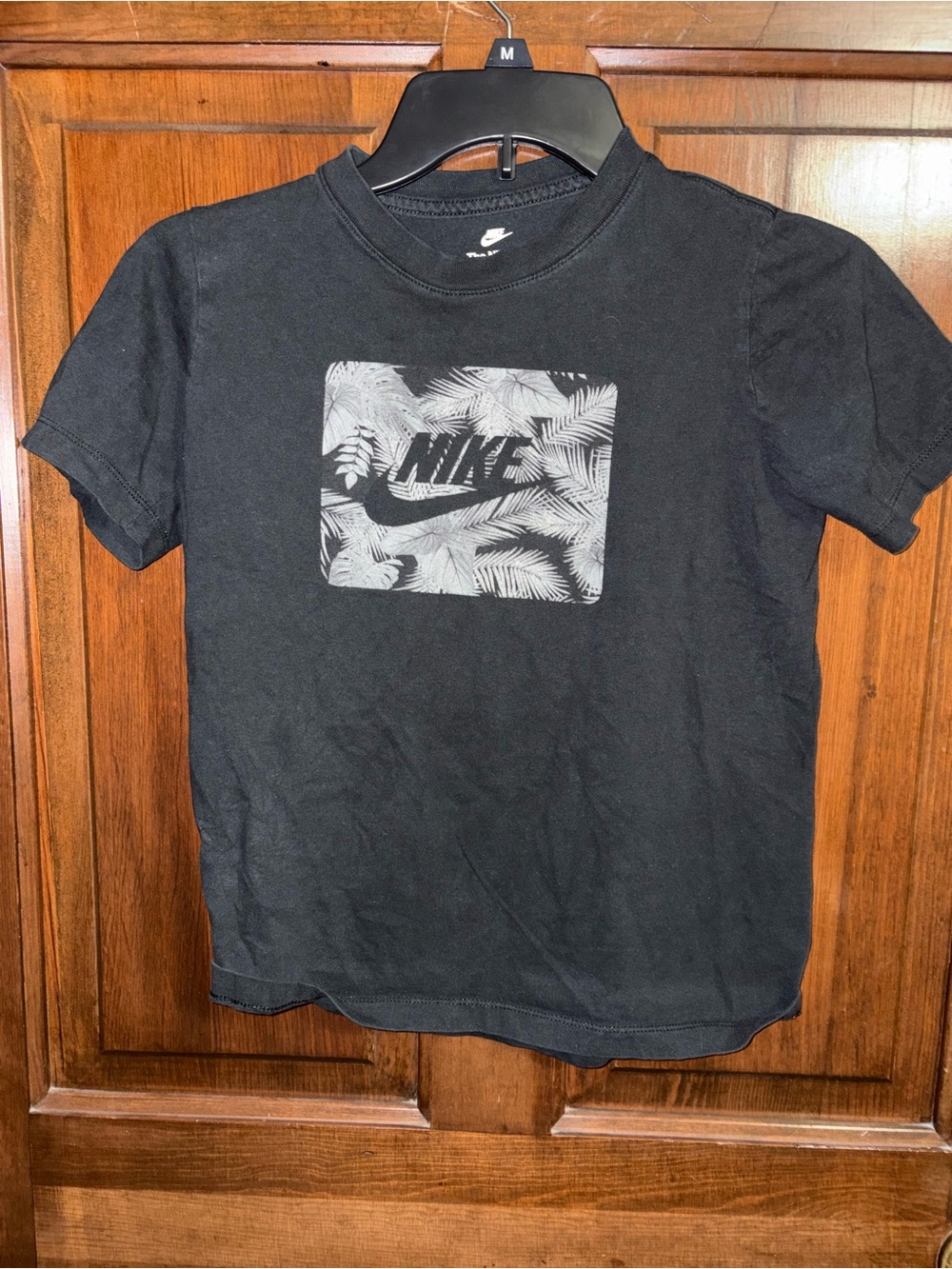 Kid’s Nike Black Tee with Gray Palm Logo Graphic